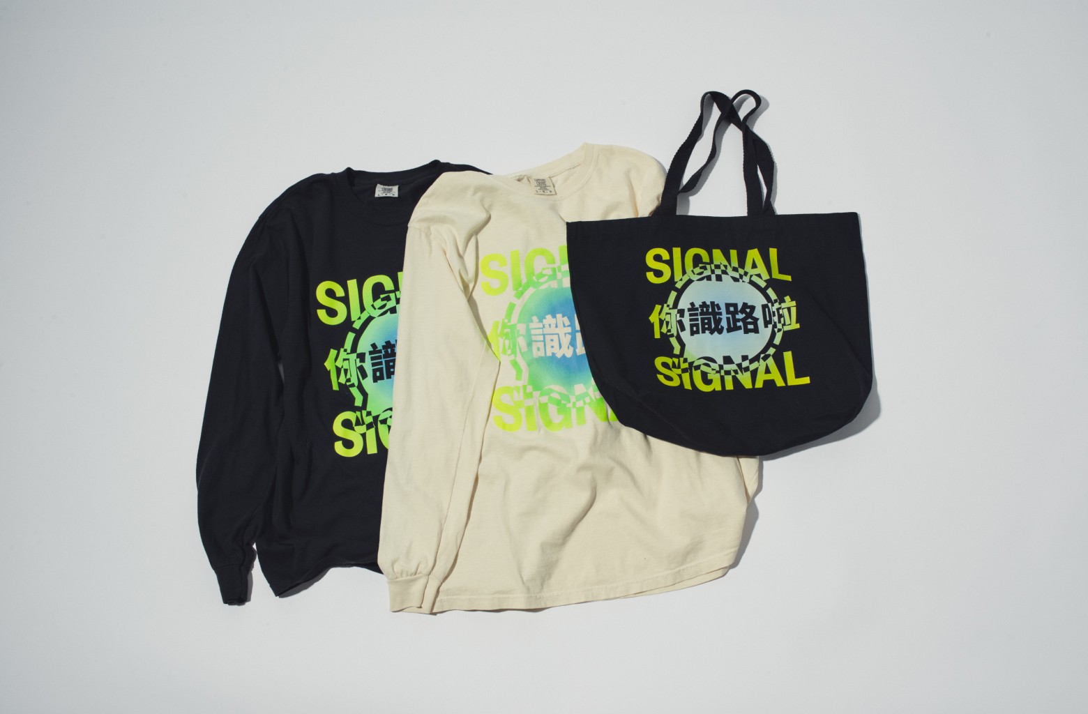 Two longsleeve shirts and a tote bag with stylized neon 99chat logo and Cantonese characters reading '你識路啦'.